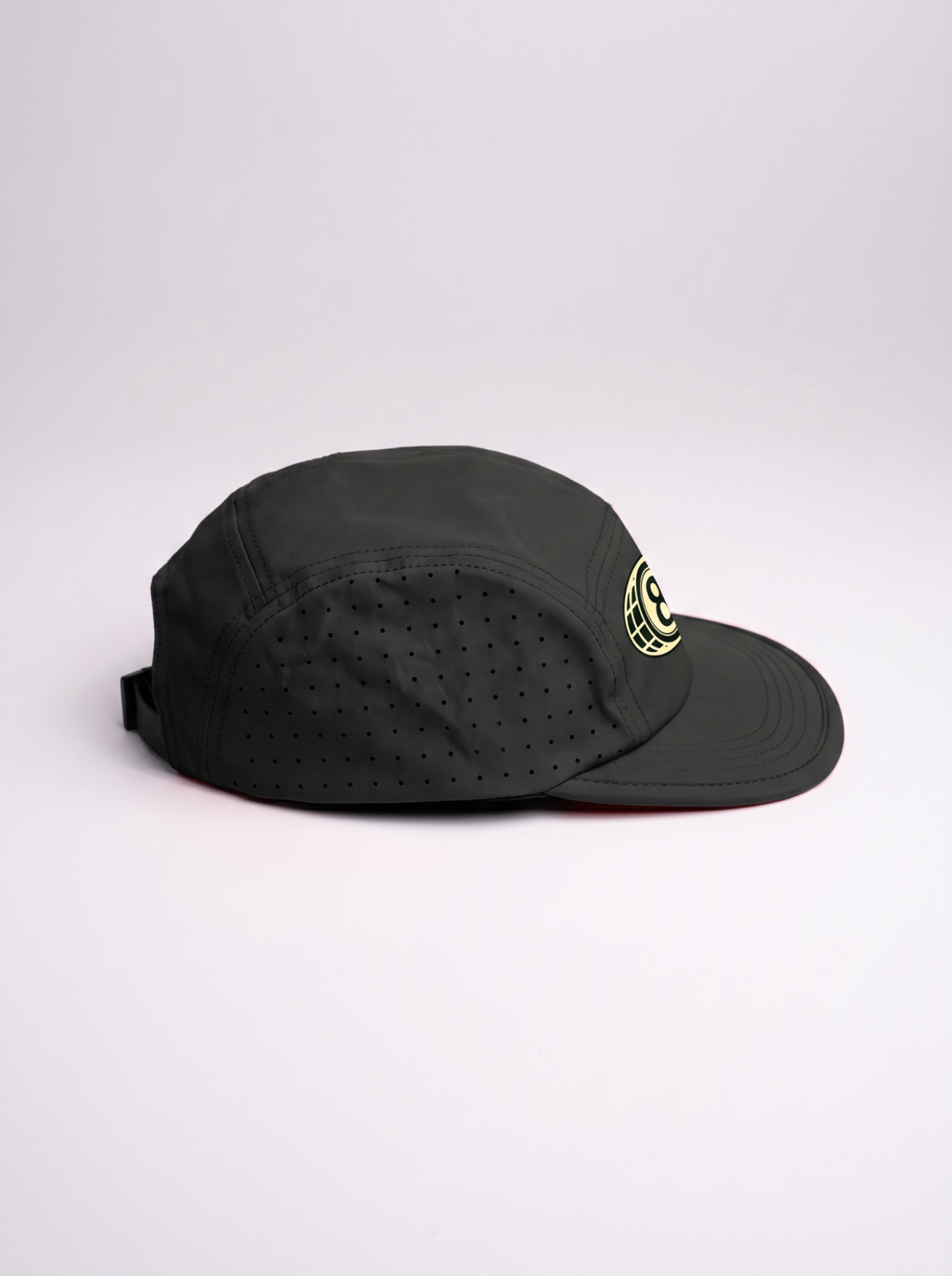 Side profile of the black 5 panel running cap showing curved bill and perforated panels